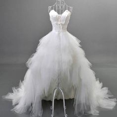 a white wedding dress is displayed on a mannequin