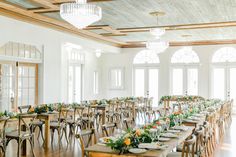 the tables are set up with flowers and greenery for an elegant wedding reception at this venue