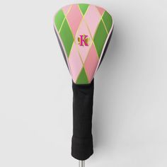 a pink, green and white umbrella with the letter k on it's side