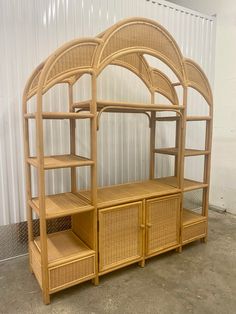 a wooden shelf with wicker shelves and baskets