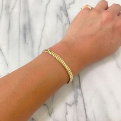 This finely handcrafted bracelet is completely composed of 14K solid gold and is finished with a lobster claw clasp . Total Length: available in your choice of 6.5 & 7 inches Bracelet Dimensions: approximately 5.8mm (W) x 2.35mm thick Weight: approximately 7 grams of 14K solid gold for the 7" option Metal Finish: High Shine Polish This design is available in 14K Yellow Gold Please note that this item takes about 3 to 5 business days for production, prior to shipping. This item is proudly finishe Yellow Gold Tarnish-resistant Snake Chain Bracelet, Yellow Gold Jubilee Bracelet With Snake Chain, Gold Plated Snake Chain Bracelet, Gold Plated Jubilee Bracelet With Snake Chain, Gold Flexible Snake Chain Bracelet, Gold-plated Jubilee Bracelet With Snake Chain, Yellow Gold Snake Chain Bracelet, Adjustable Yellow Gold Snake Chain Bracelet, Flexible Yellow Gold Snake Chain Bracelet