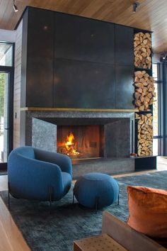 a living room filled with furniture and a fire place next to a wall mounted fireplace