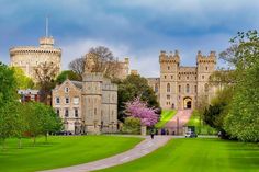 a large castle sitting on top of a lush green field