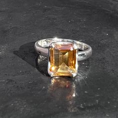 Rectangle faceted citrine ring with filigree design is set in sterling silver, handmade and fair-trade. Shape - Oval Stone Origin - Brazil  Stone Hardness - 7 Metal - 925 sterling silver Weight - 4.1 grams Ring size  -  U.K - O 1/2  U.S. - 7 E.U. - 55 / 15  Stone size -  L 1.1 x B 0.9 x H 0.7 cm L 0.45 x B 0.35 x H 0.3 inch  Band width - 0.3 cm Healing properties - abundance , optimism , self-worth , will power, protection  Shipping - Royalmail recorded Yellow Emerald-cut Topaz Ring, Yellow Citrine Topaz Ring Rectangular Shape, Octagon Citrine Gemstone Ring, Citrine Ring With Rectangular Stone For Gift, Citrine Rings With Rectangular Stone For Gift, Yellow Citrine Rectangular Rings, Yellow Rectangular Citrine Ring, Silver Rectangular Topaz Ring, Rectangular Citrine Gemstone Ring