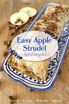 an easy apple strudel is cut in half on a blue and white plate