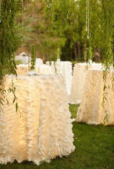 tables covered with white tablecloths and greenery