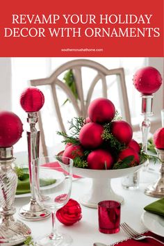 a white table topped with red ornaments and candles