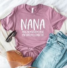 a t - shirt that says nana on the front, and two pairs of jeans