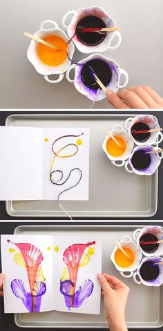 two children's hands are painting flowers with watercolors on paper and coffee cups