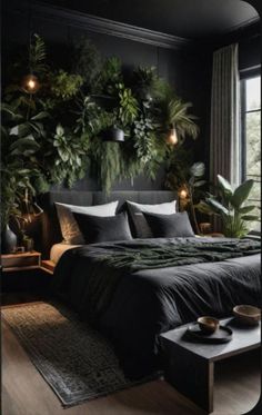 a bedroom with black walls and plants on the headboard, along with a large bed