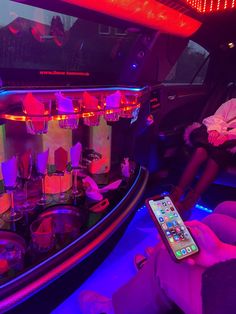 the interior of a car is lit up with purple and red lights as well as remote controls