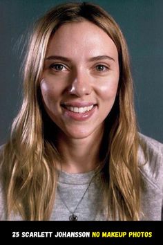 a woman with long blonde hair smiling at the camera while wearing a gray shirt and necklace