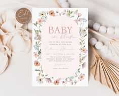 a baby is born card with flowers and shells on the table next to seashells