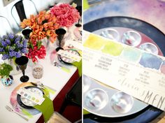 the table is decorated with colorful flowers and plates