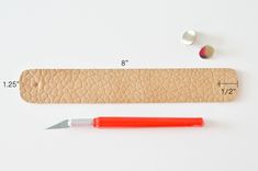 a pencil and ruler sitting next to each other