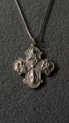 I am offering you this truly exquisite sterling silver (stamped) cross pendant charm, and necklace chain. This is one of the most spectacular cross pendant charms I have ever sold, with lots of etched scroll and raised relief work. The necklace chain is a sturdy box link chain, that measures 23 inches long. This amazing cross pendant charm has such thickness and dimension, and measures 1 1/4 inches by 3/4 inch, including the bail. It weighs app. 7 grams. Buyer pays all shipping and handling fees Etched Sterling Silver Cross Necklace, Vintage Engraved Silver Cross Necklace, Silver Etched Cross Pendant Jewelry, Antique Engraved Cross Pendant Necklace, Vintage Sterling Silver Cross Pendant Necklace, Chain Jewelry, Cross Pendant Necklace, Necklace Chain, Chains Jewelry