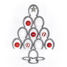 a metal christmas tree with red and white ornaments on it's sides, in the shape of an ornament