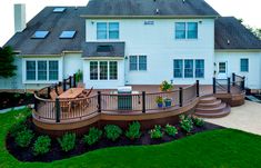 a large white house with a wooden deck