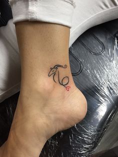 a woman's foot with a small tattoo on the side of her left leg