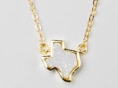 The Texas Opal Necklace combines two of our favorite things, Texas and Opal. The natural stone gives a bit of sparkle to this handmade adjustable 18K gold plated necklace. Makes a statement with other dainty pieces stacked to glow along with the fiery opal necklace. Perfect for your favorite Texan. Pairs well with the Texas Opal Bracelet, or continue the stack with the dainty Opal Necklace. Handmade in Houston, TX USA 18K gold plated Due to the one of a kind nature of the stone, each piece is un Adjustable Gold Opal Jewelry, Gold Opal Charm Necklace As Gift, Adjustable Gold Charm Necklace With Gemstone, Handmade Gold Opal Necklaces, Handmade Opal Gold Necklace, Handmade Gold Opal Necklace, Opal Jewelry With Adjustable Chain For Gift, Dainty Adjustable Opal Necklace, Dainty Opal Adjustable Necklace