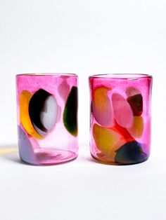 two colorful glass cups sitting next to each other