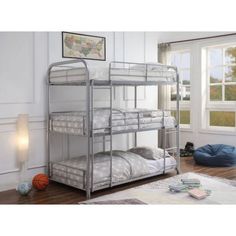 a metal bunk bed sitting in a bedroom next to a window