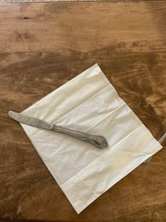 a table with a knife and napkin on it