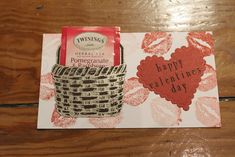 a valentine's day card with a basket and heart shaped candy bar on it