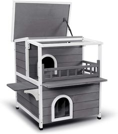 a gray and white dog house that is open to show the top part of it's roof