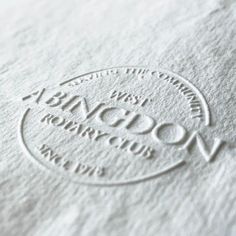 a close up of a white paper with the words on it and a circle logo