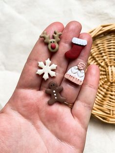 a person is holding some miniature christmas decorations