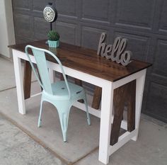 a table and chair sitting in front of a garage door with the word hello written on it