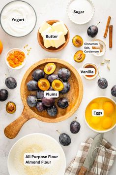 the ingredients to make an orange and plum smoothie laid out on a table