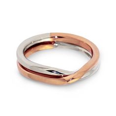 two tone gold and silver wedding band with an open design on the inside, set against a white background