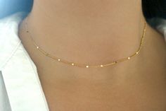 Tiny twinkling gold bars have been set on rich 24k gold plated chains to create this mesmerizing dainty necklace, perfect for layering. The 1.7mm 24k gold plated chains are finished with a 24k gold plated lobster claw clasp. This necklace is made to order. The necklace shown in the photos is adjustable 12 - 15 inches long. Would you like a length that isn't listed? Have an idea for a custom order? Please contact me and I will be very happy to help you! More matching starlit gold jewelry can be f Dainty Gold Choker With Satellite Chain, Dainty Yellow Gold Chain Necklace For Party, Minimalist Gold Choker With Satellite Chain, Gold Dainty Bar Necklace With Adjustable Chain, Gold Bar Necklace With Satellite Chain, Dainty Gold Bar Necklace With Adjustable Chain, Gold Delicate Chain Choker, Gold Chain Necklace With Simple Design For Gift, Simple Gold Chain Jewelry