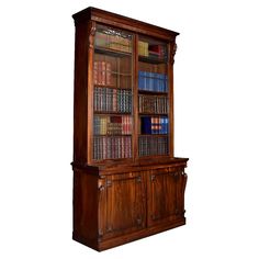 an old wooden bookcase with many books on it