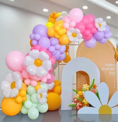 balloons and flowers are on display in the lobby at a children's day event