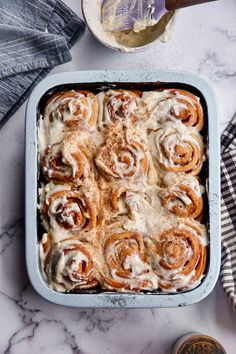 the best cinnamon roll recipe is shown on a table with other food and utensils