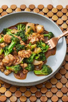 a white plate topped with broccoli and meat