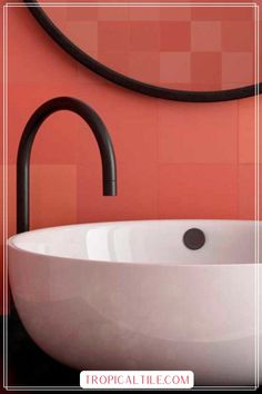 a white sink sitting under a mirror next to a faucet in a bathroom