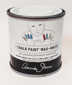 a can of chalk paint sitting on top of a white table