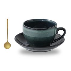 a black cup and saucer with a spoon