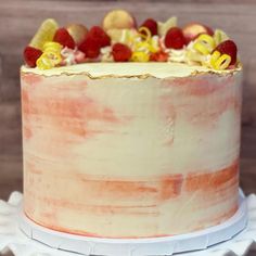 a close up of a cake with fruit on top