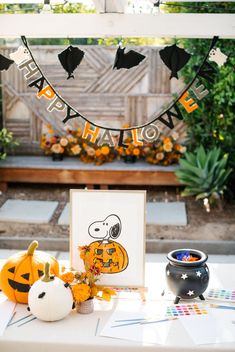 a table topped with pumpkins and decorations