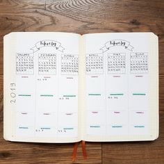 an open planner book on a wooden table with the pages numbered in numbers and arrows