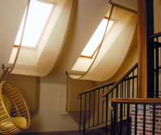 the sun shines through three windows in an empty room with a hammock chair