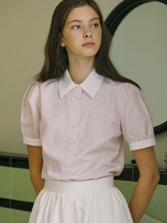 This product is a classic striped shirt with a contemporary twist, featuring puff half sleeves that add a touch of playful sophistication. The crisp collar and button-down front give it a timeless appeal, while the shirt's tailored fit flatters the silhouette. Made from a light and breathable fabric, it's a versatile piece that can be dressed up for the office or styled casually for a weekend outing. - The shirt's puff half sleeves offer a modern update to the conventional sleeve design.- A traditional button-down front ensures a neat and polished look suitable for various occasions.- Its light-striped pattern is both subtle and stylish, lending itself to a variety of pairing options.- The fabric is chosen for comfort and ease, ensuring the shirt is as practical as it is fashionable. Classic Puff Sleeve Shirt With Button Closure, Elegant Striped Short Sleeve Shirt, Short Sleeve Tops With Striped Collar For Work, Short Sleeve Shirt With Striped Collar For Work, Classic Short Sleeve Blouse With Striped Collar, Short Sleeve Blouse With Striped Collar For Work, Short Sleeve Top With Striped Collar For Daywear, Daywear Blouse With Striped Collar And Short Sleeves, Classic Striped Short Sleeve Shirt For Spring