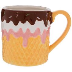 a yellow and brown coffee cup with ice cream on it's rim, sitting in front of a white background