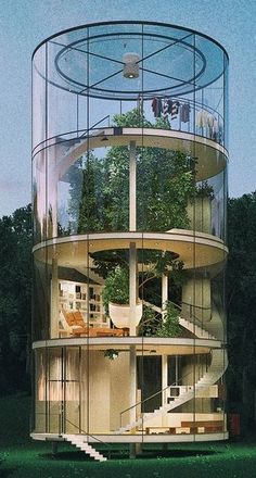 a tall glass tower sitting in the middle of a forest