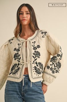 Introducing the Lena shacket, a playful twist on the classic quilted shacket. Adorned with stunning floral embroidery and tied in the front, this ivory jacket is sure to turn heads. Stay cozy and chic in this adorable piece. *THE ITEM IS ESTIMATED TO ARRIVE ON THE DATE ABOVE* Details + Fit 60% Rayon | 40% Polyester Runs True to Size Hand Wash Cold Hang Dry Round Neckline Long Sleeves Front Self Tie Quilted Floral Embroidered Design Ivory | Multi | Printed Model is 5'8" and wearing a size Small Embroidery Jackets For Women, Quilted Shacket, Tie Quilt, Womens Quilted Jacket, Knit Bottom, Velvet Jacket, Crop Top Sweater, Embroidered Jacket, Short Sleeved Sweaters